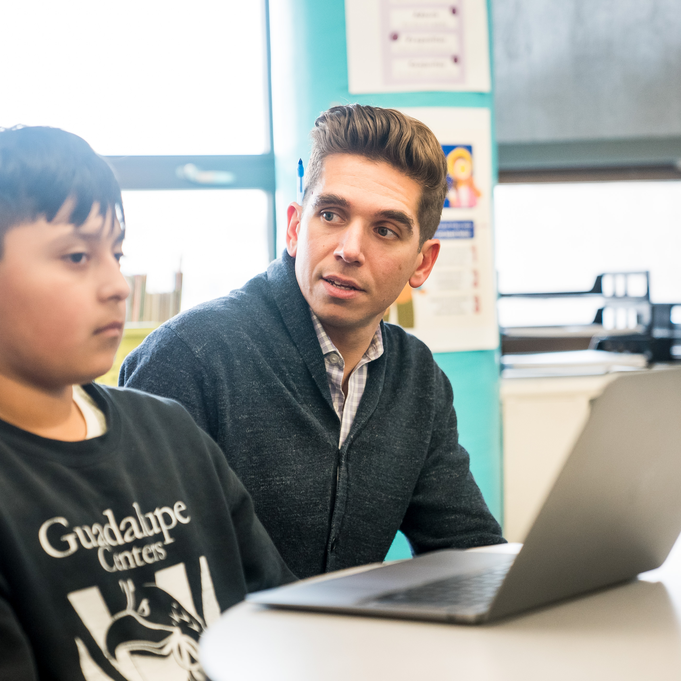 Teacher speaking with student during a lesson