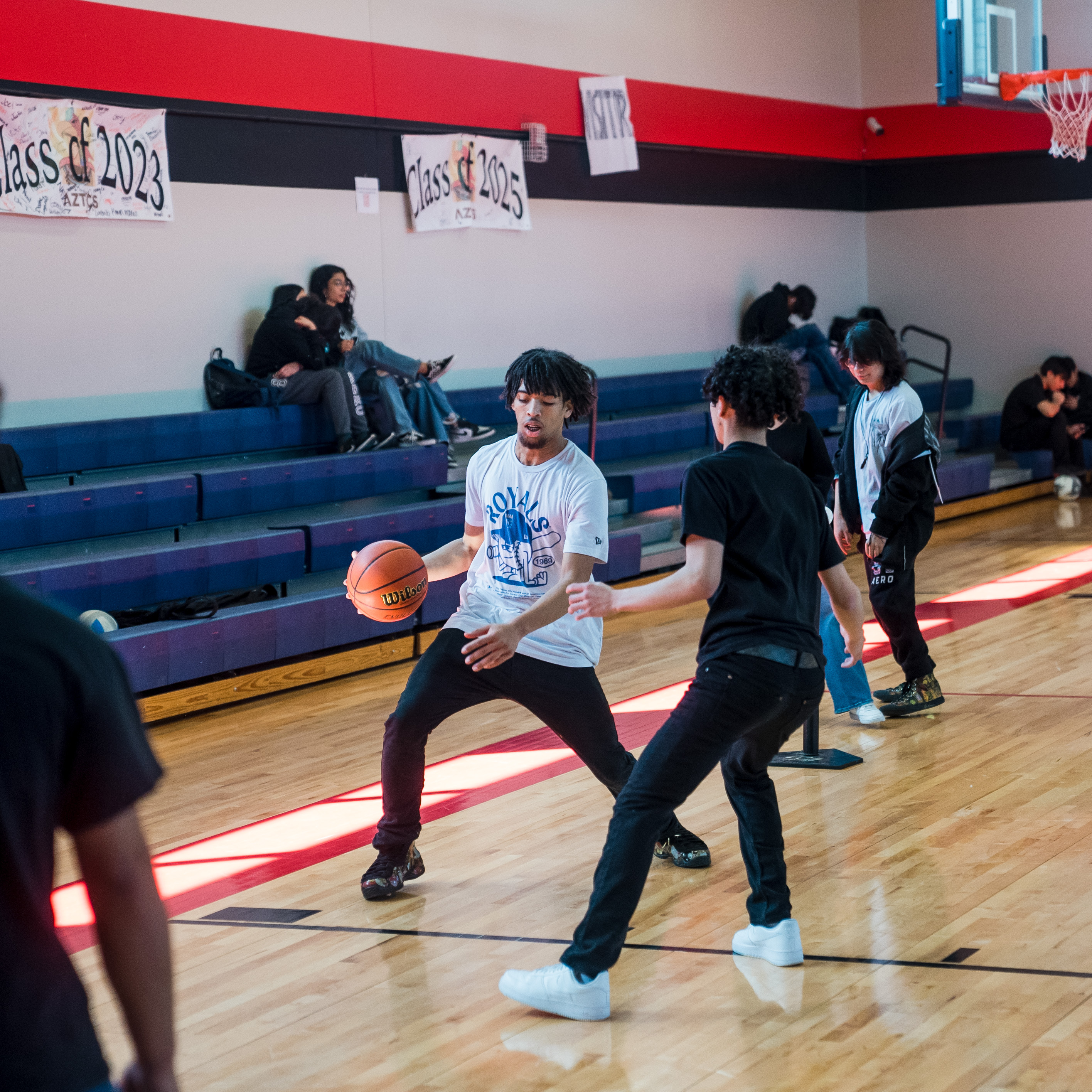 Students playing basketball in the high school gym