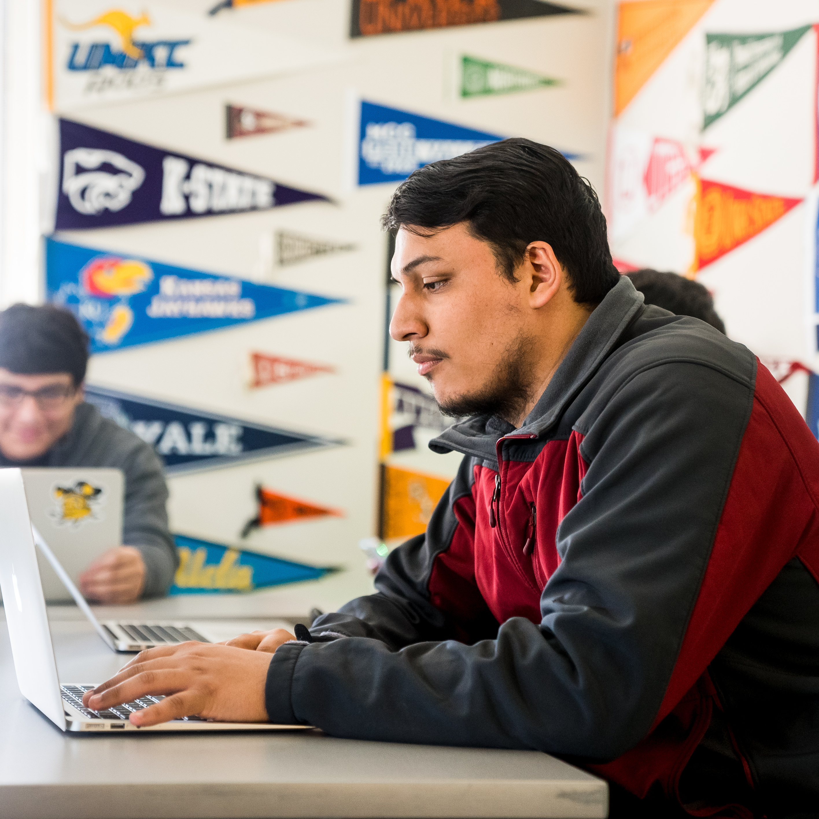 student working on his laptop in class 