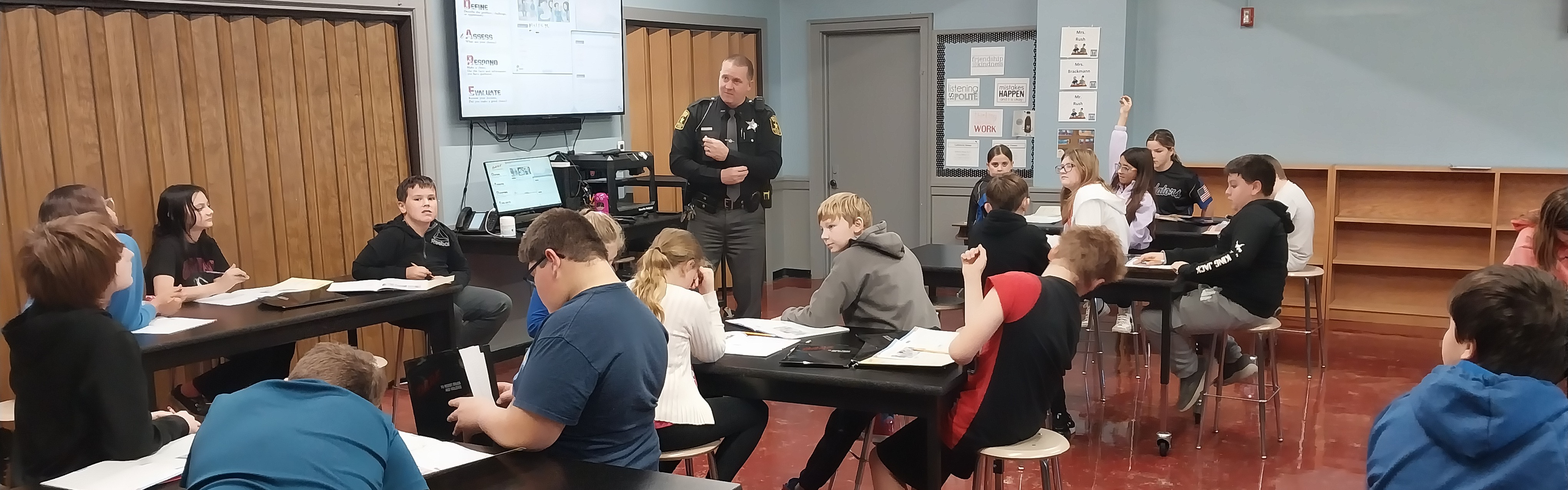 JG students listening to a police officer in class.