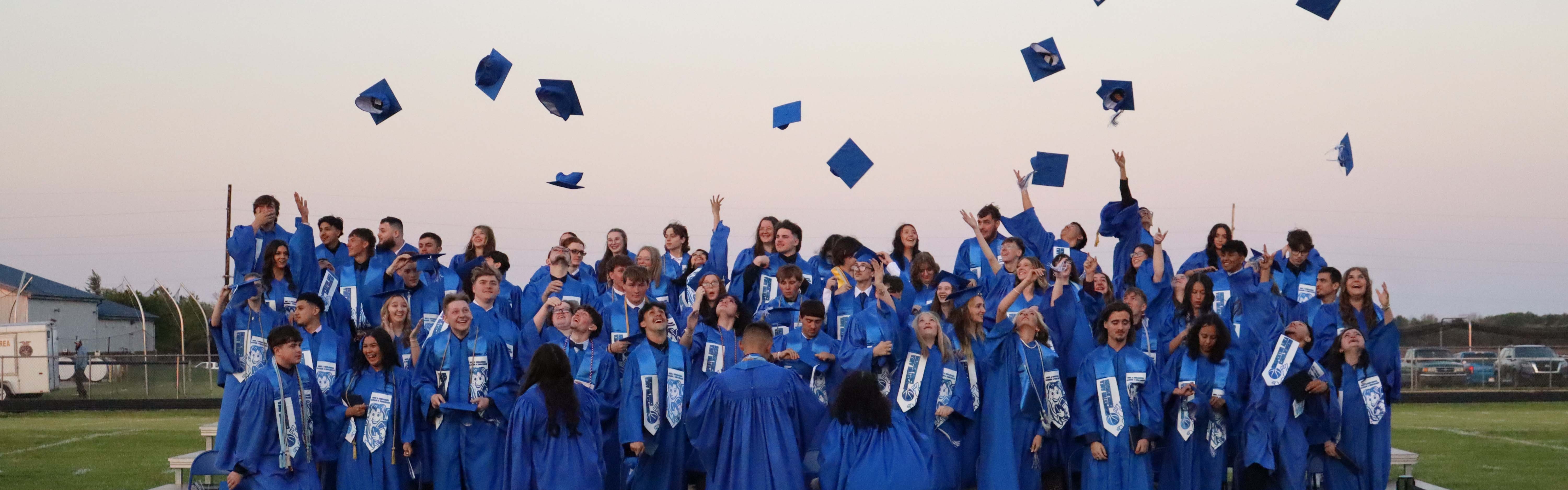 Class of 2026!  Congratulations! thorwing their caps in the air.