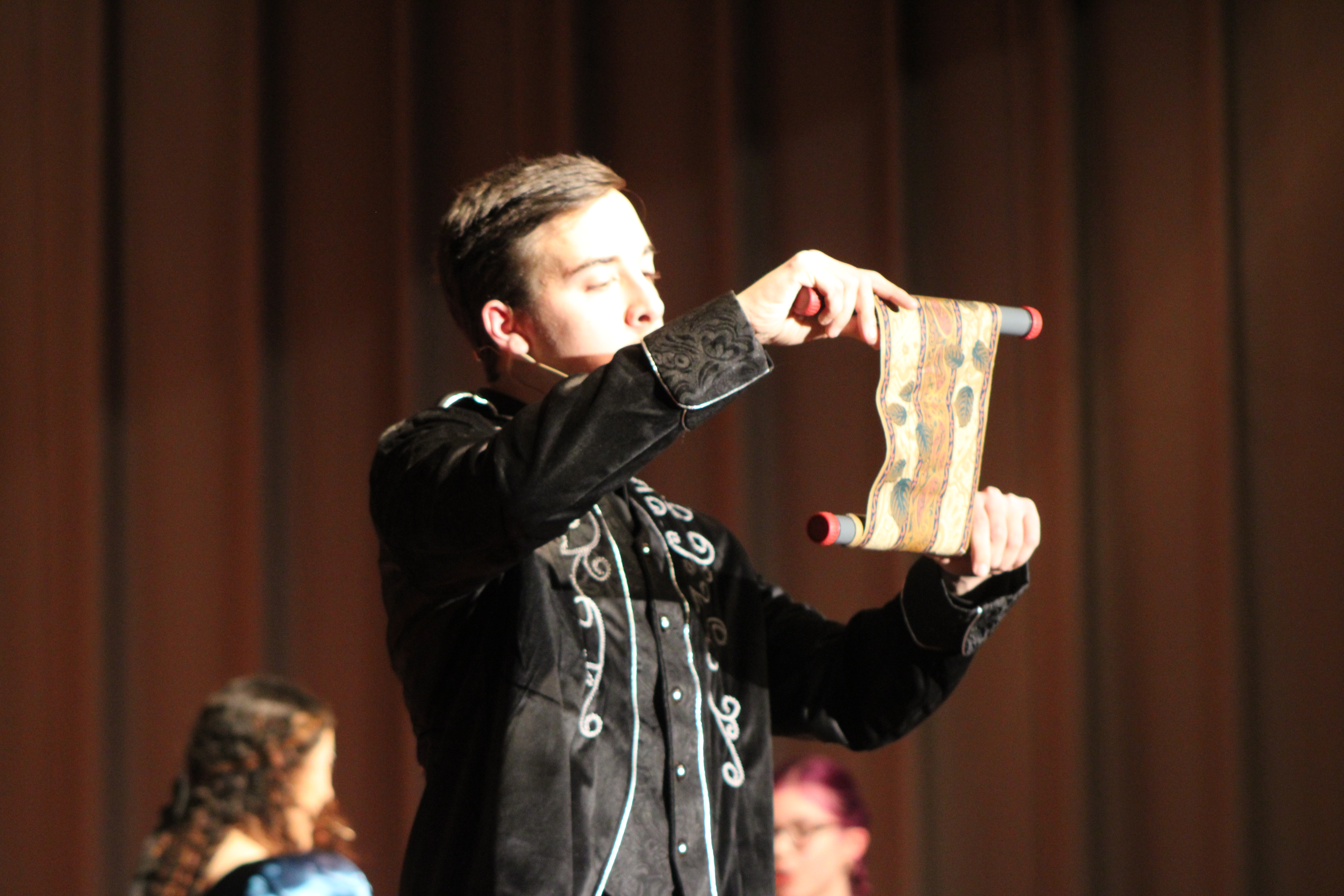M. Vines reading a scroll.