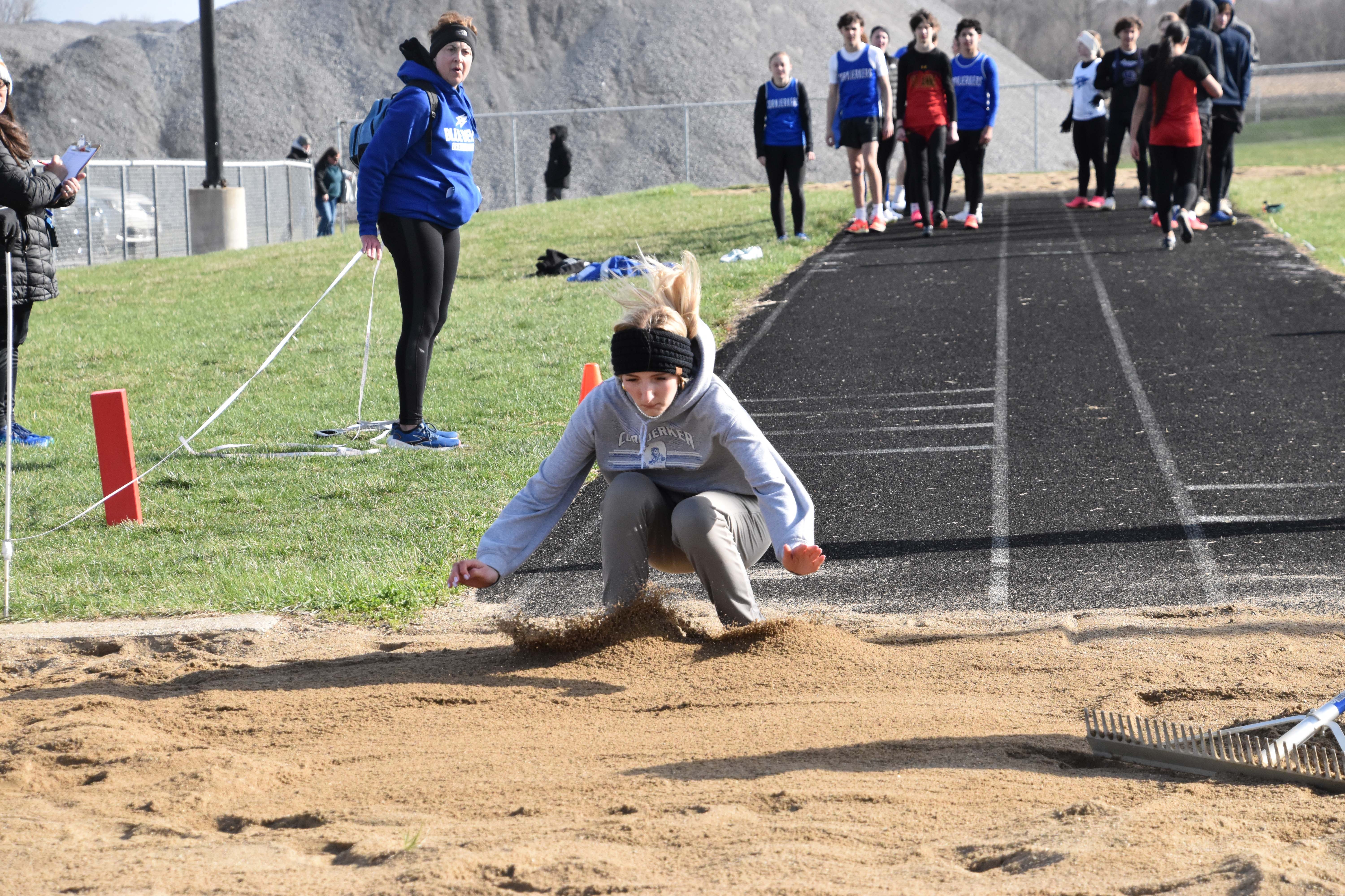 Abbie landing on her long jump attempt.