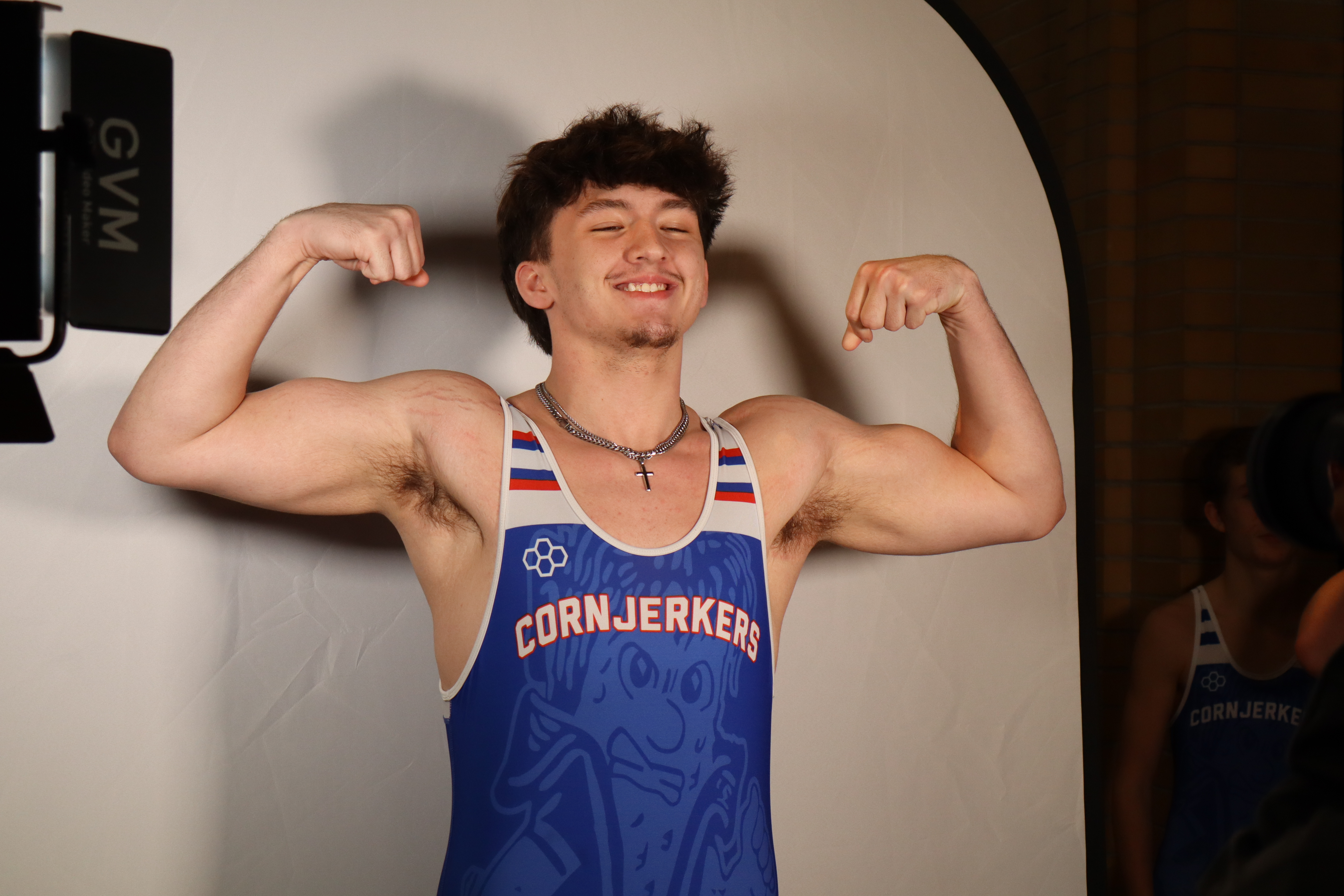 Showing his muscles off.