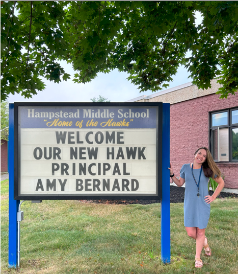 Principal of Hampstead Middle School, Amy Bernard, standing next to welcome sign outside of the middle school