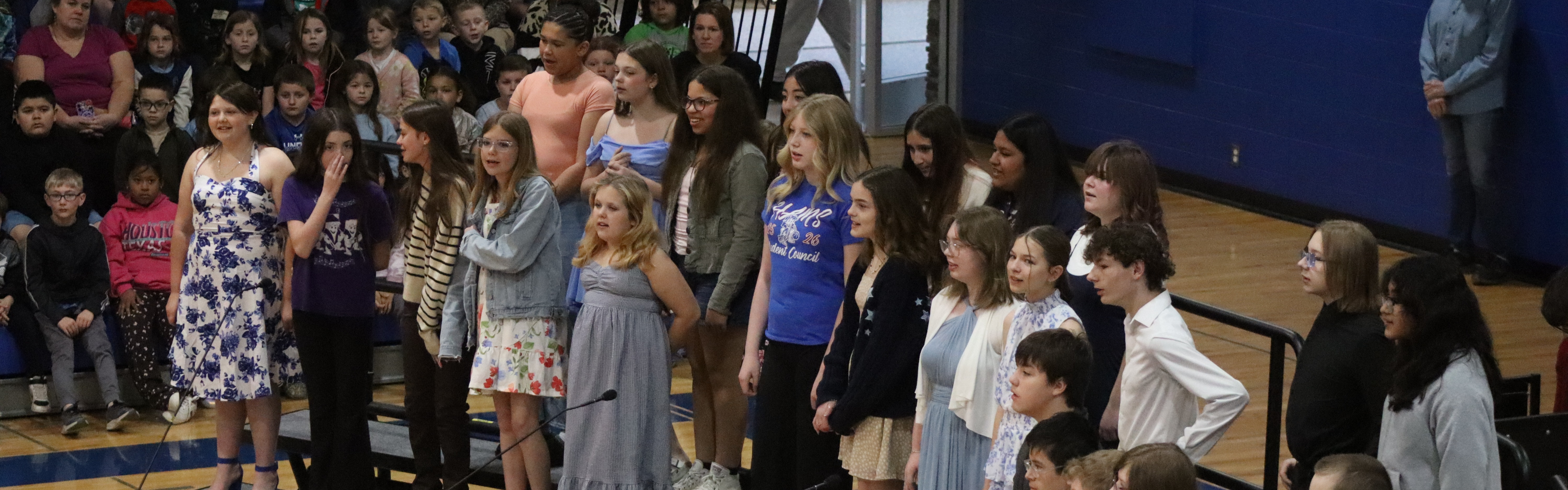 HAMS chorus sining to the other schools in the MS gym.