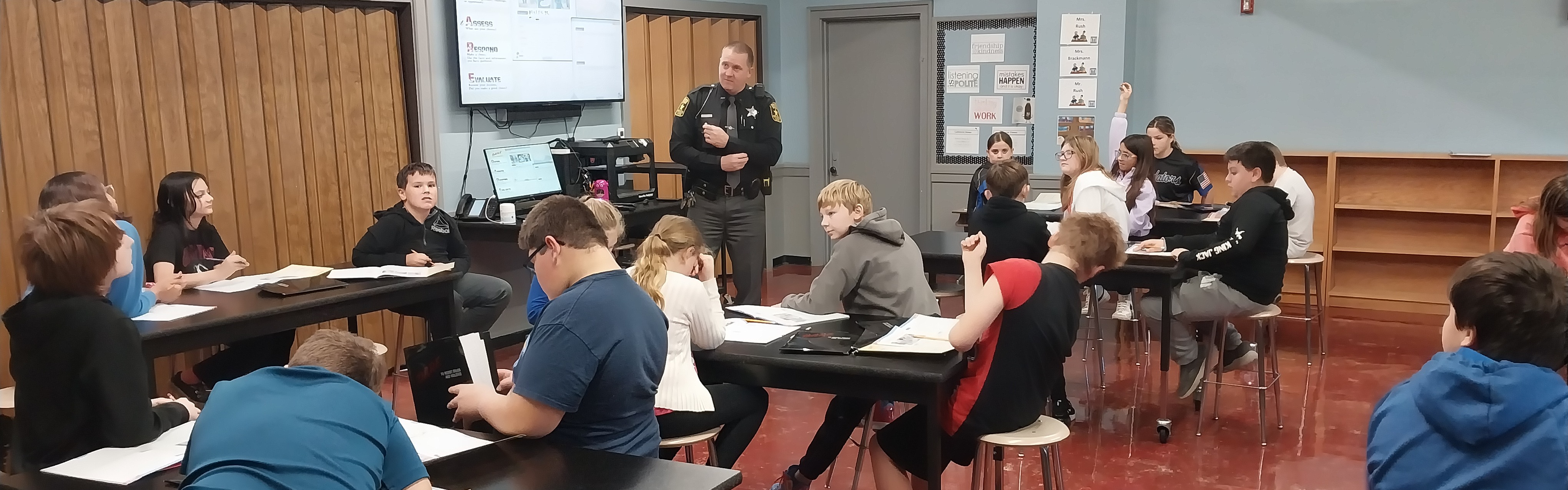 John Greer class  listening to a police officer.