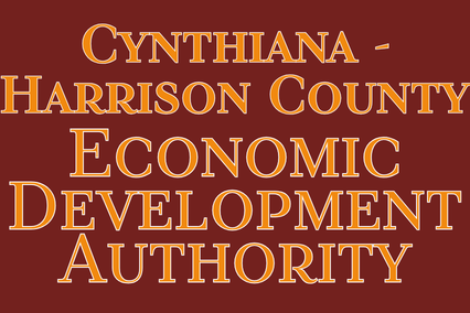 A sign displays text in bold yellow font on a maroon background. It reads "Cynthiana-Harrison County Economic Development Authority".