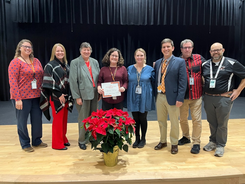 Kim McComb with upper level administration receiving her award.