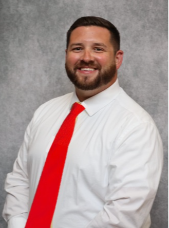 photo of athletic director in white shirt and red tie