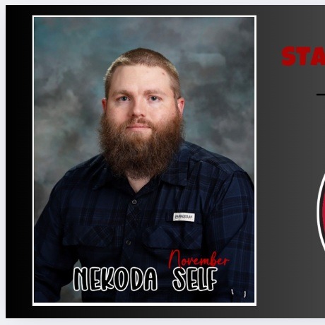 photo of male in flannel shirt button up with beard smiling for staff of the month photo