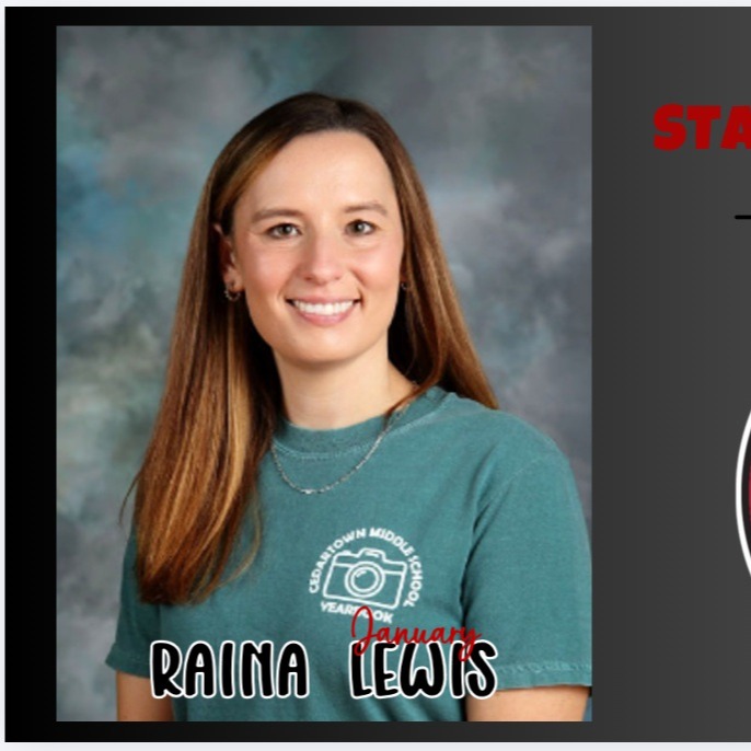 Teacher of the month smiling with braown long hair in light green yearbook tshirt