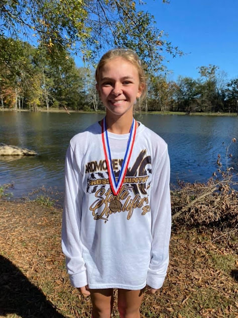 Medium shot image of cross country runner with medal;