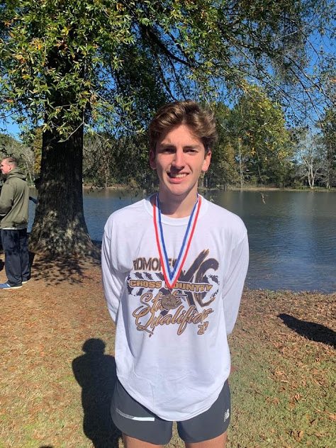 Medium shot image of cross country runner with medal;