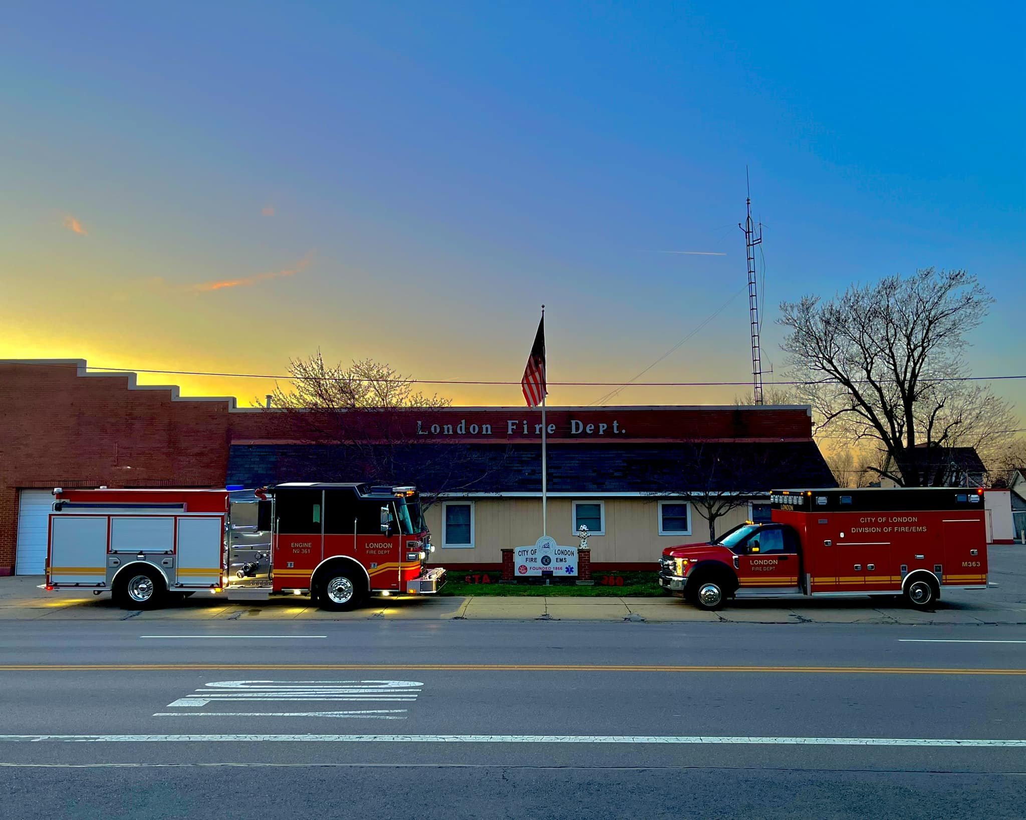 landscape photo of the london fire department with a fire truck and EMS vehicle parked out front. 