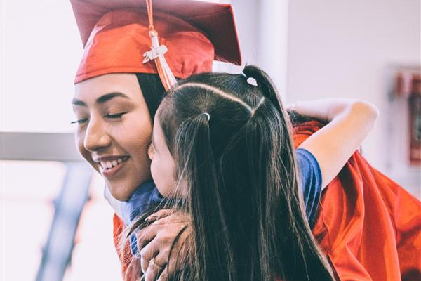 Options grad hugs a family member