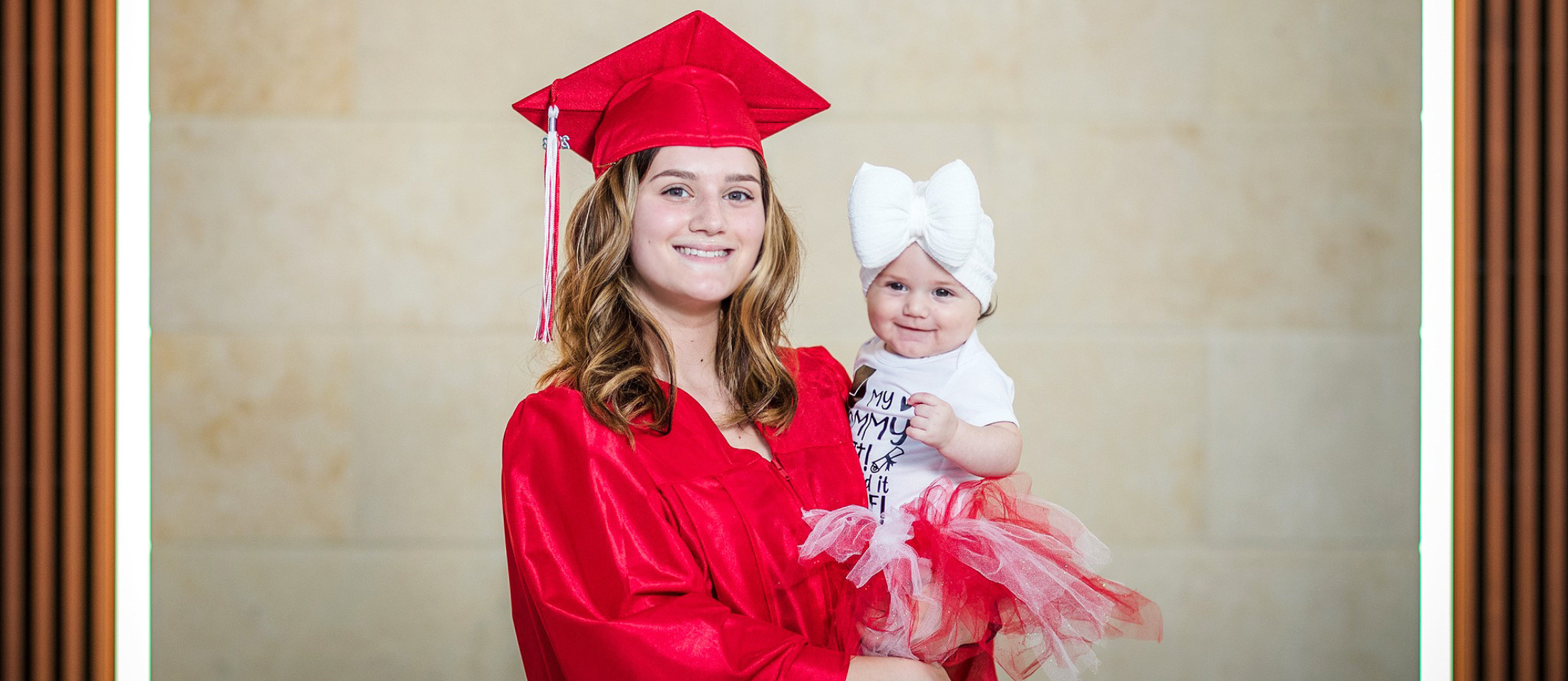 Options Graduate in Cap and Gown with baby