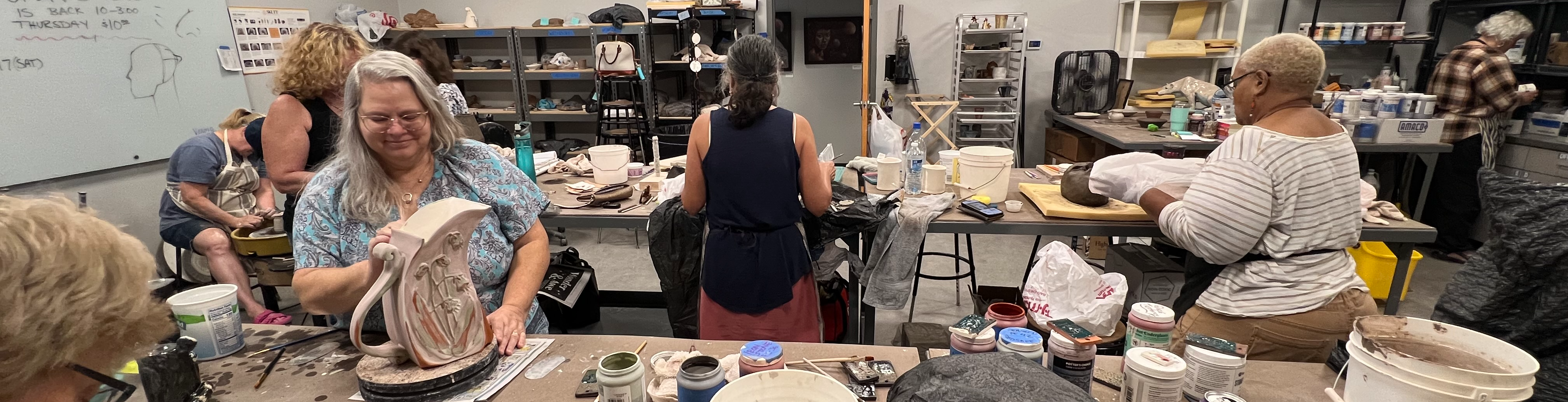 a classroom full of students during a clay class