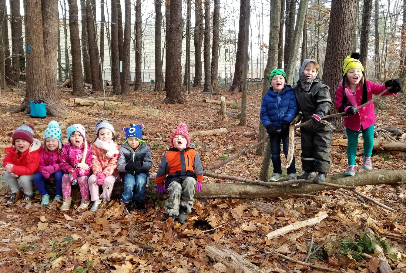 Kids outside in a wooded area