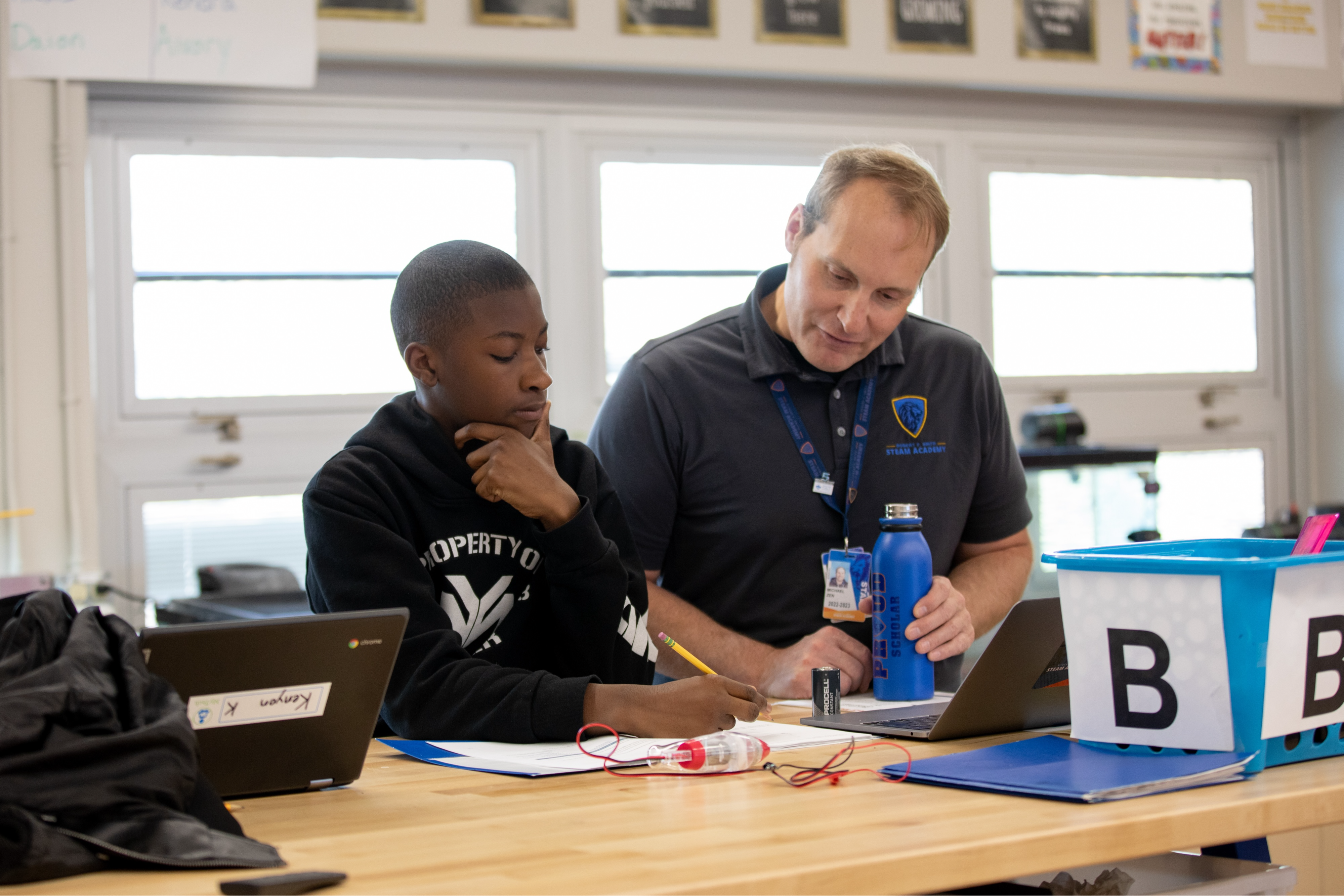 teacher helping student with written work