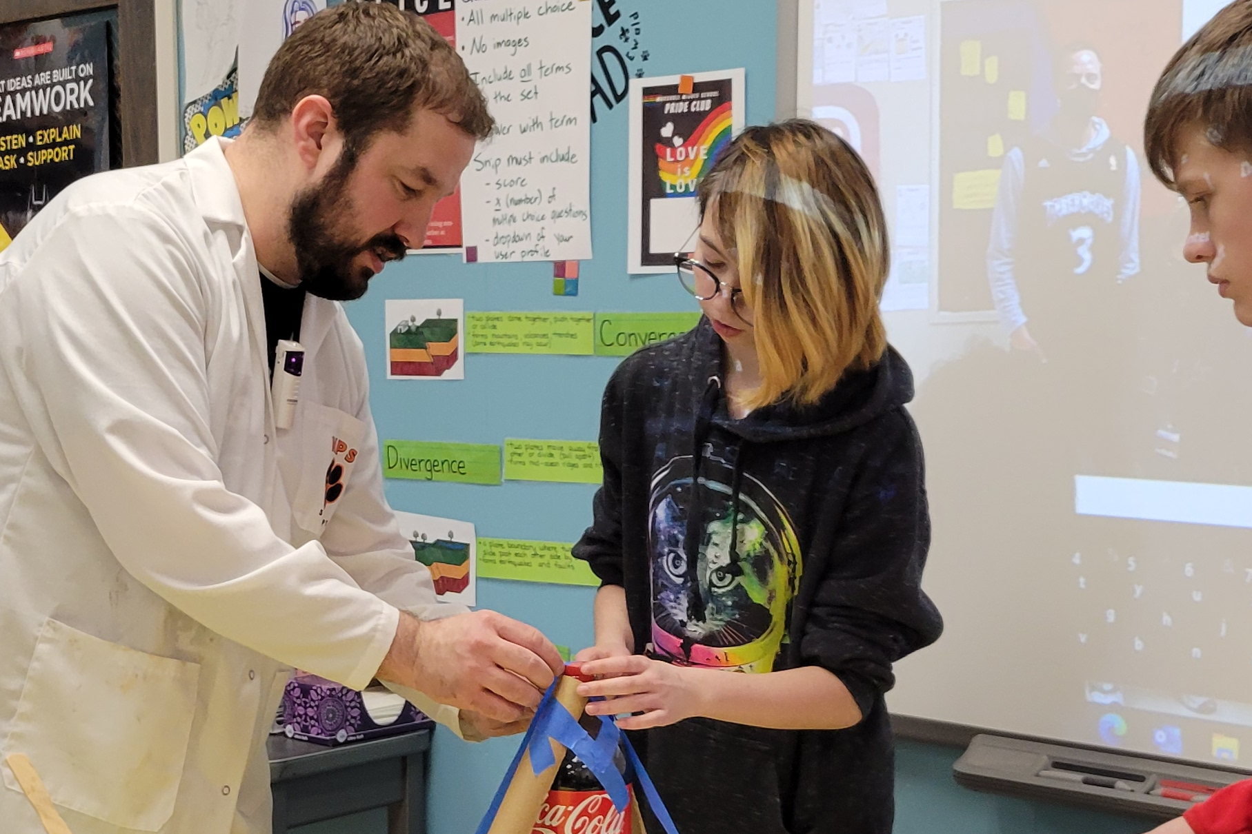 Science Teacher Assisting Student