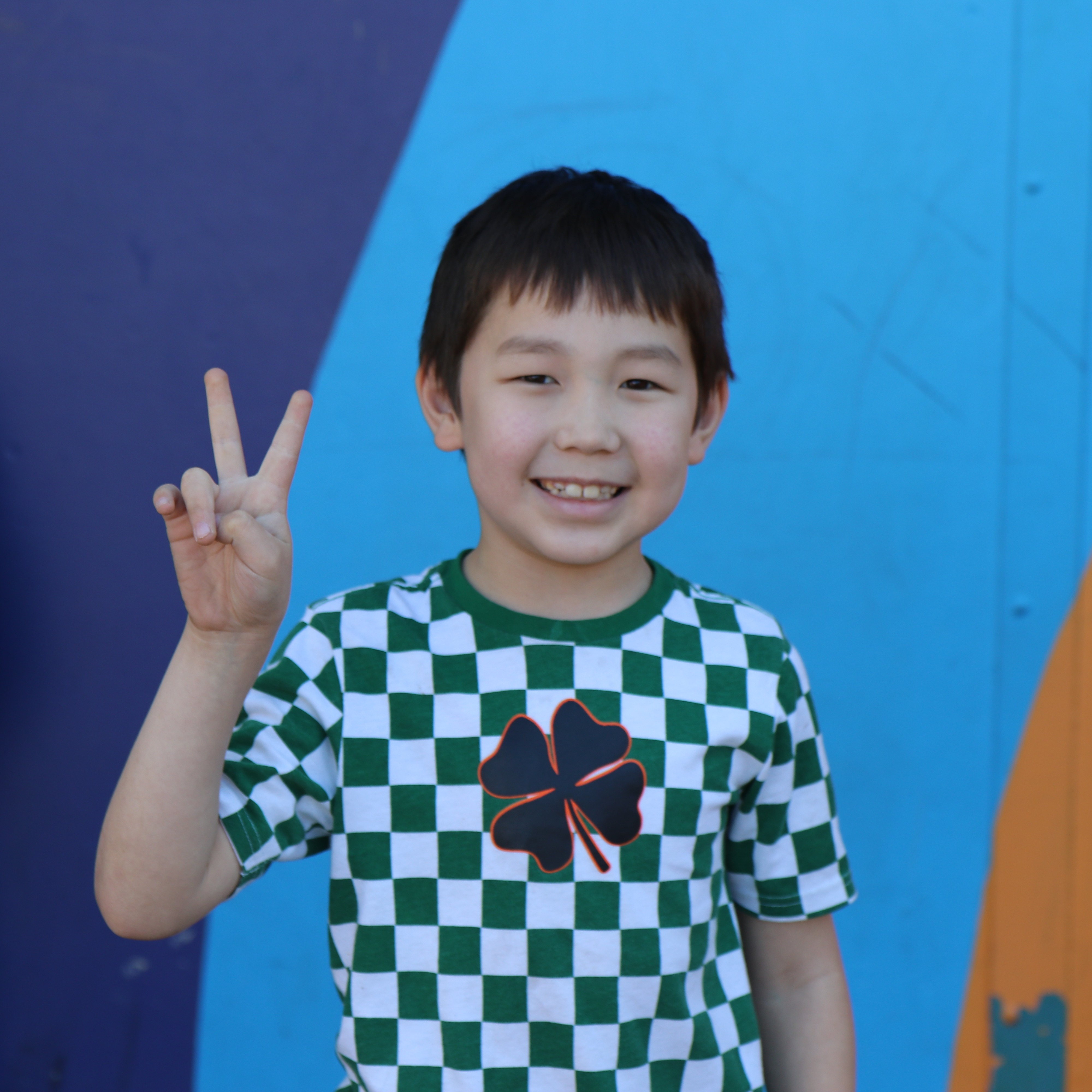 kid giving the peace sign