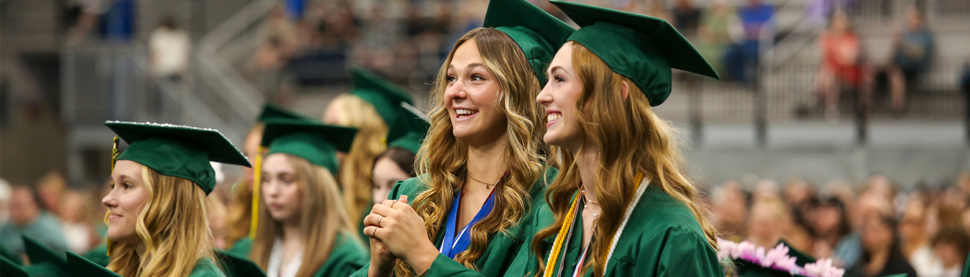 Two graduates smiling