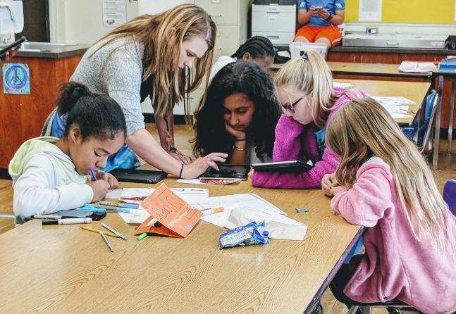 Kids learning at classroom table