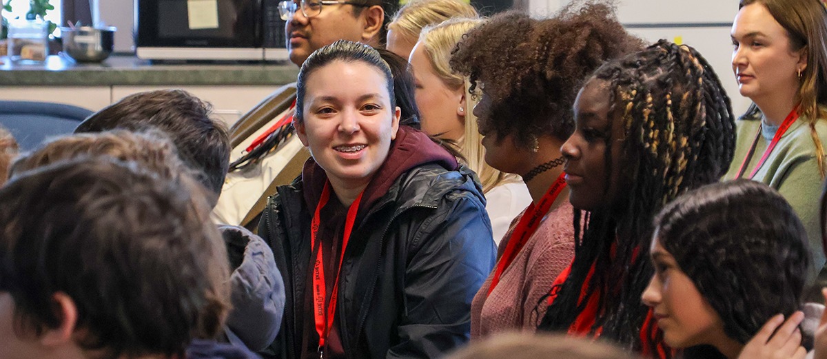 Student smiling at camera in group
