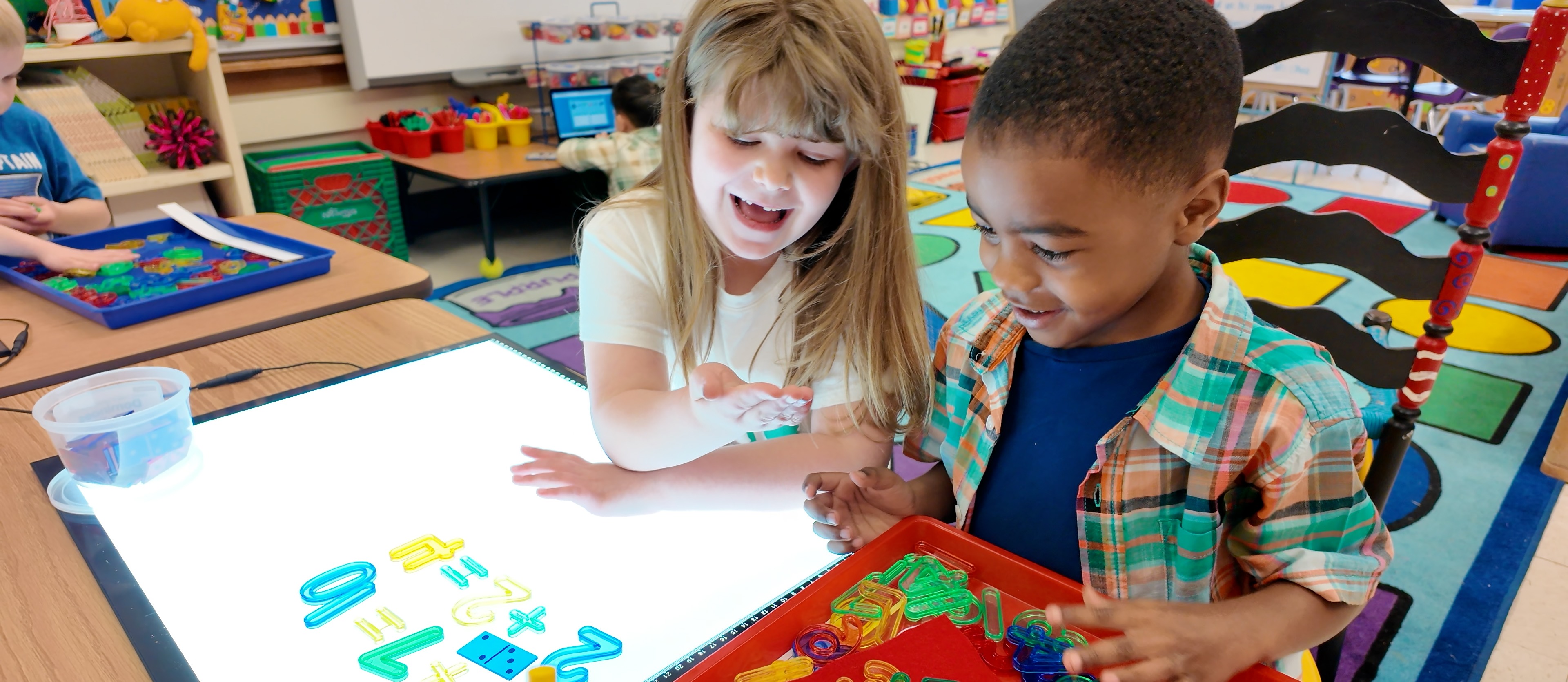 Boy and girl doing math problems in classroom