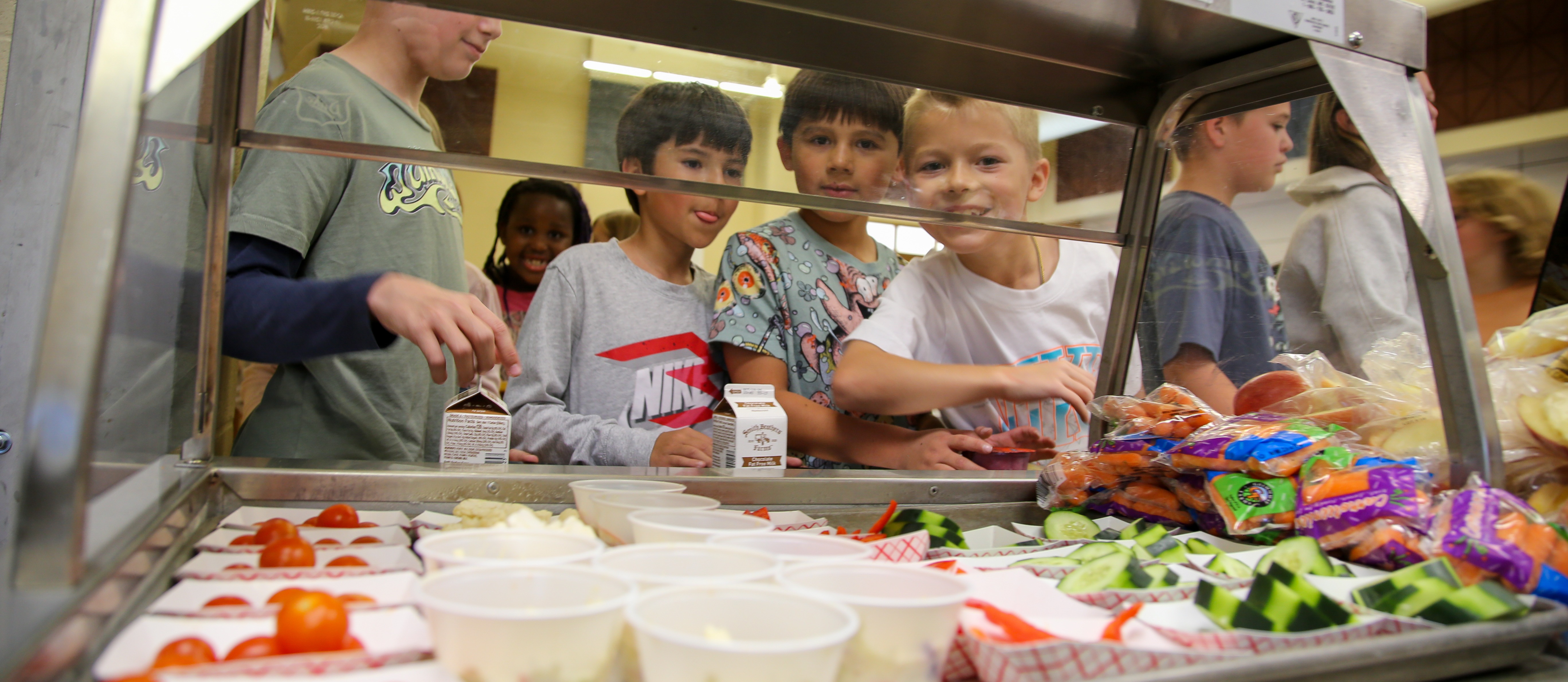 Kids smiling outside the lunch cart