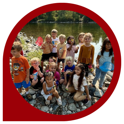 Elementary school students participating in outdoor education by the river