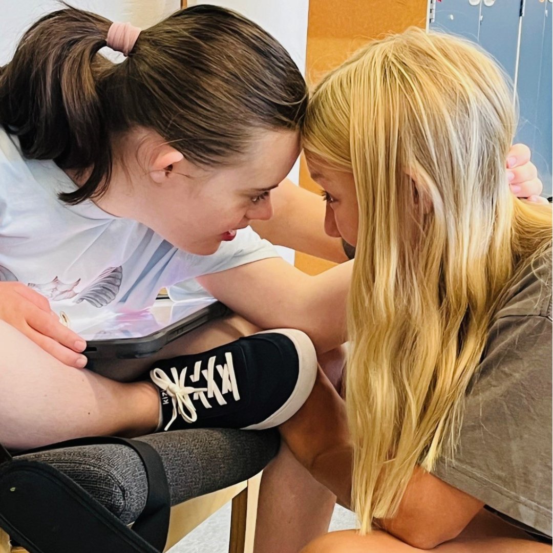 Two students hugging each other
