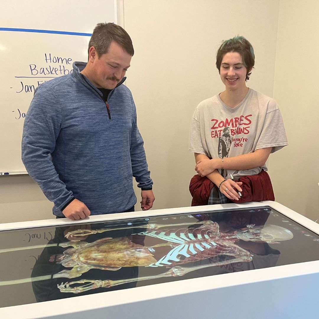Student and teacher using Anatomage table to learn about anatomy. 