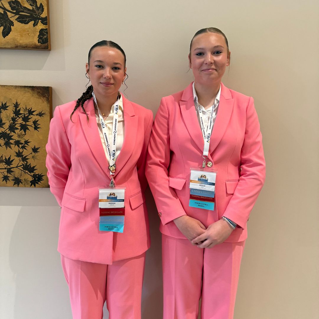 Two girls in pink suits at state business competition
