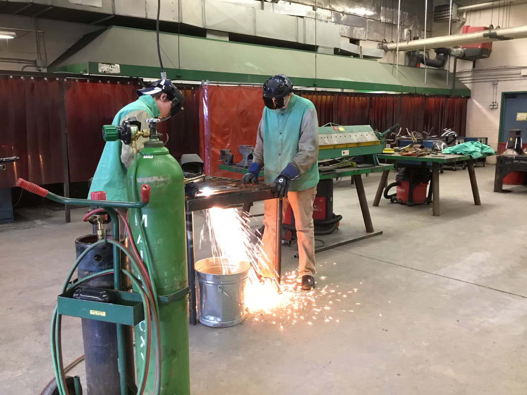 two students welding