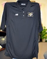 A polo shirt with a small logo of the school.