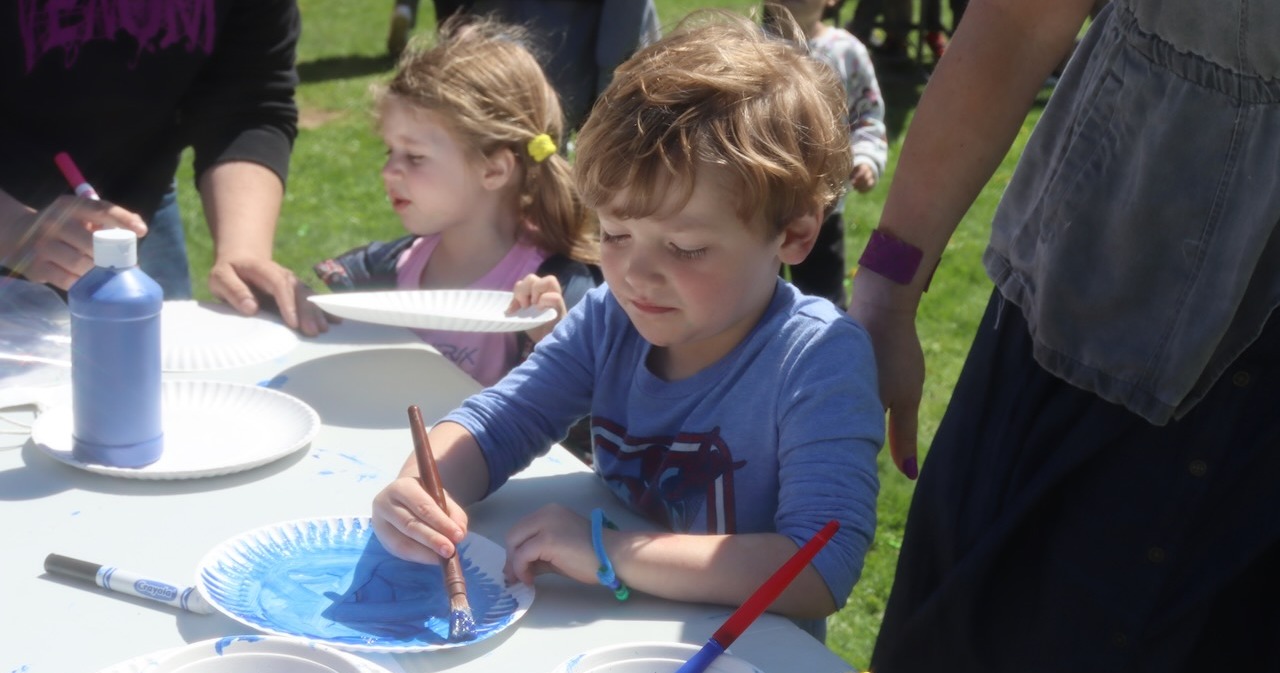 Pre-K students doing a craft outside