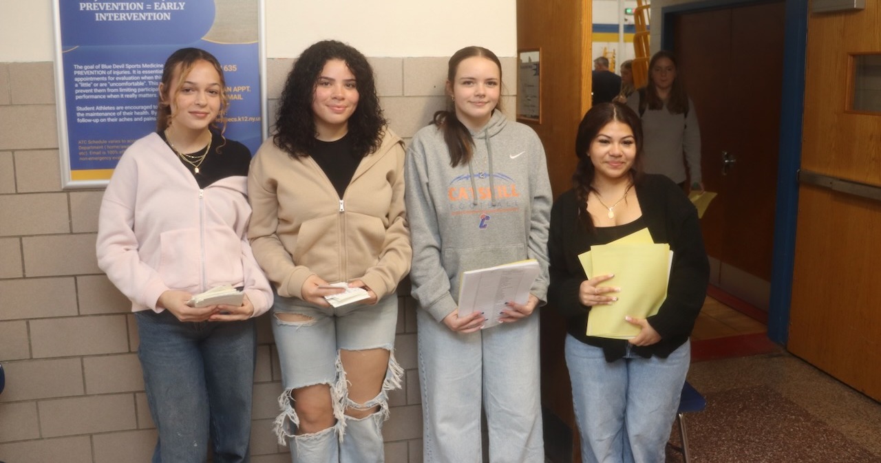 Four students standing in front of lockers
