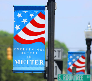 telephone pole flag that says everything's better in metter