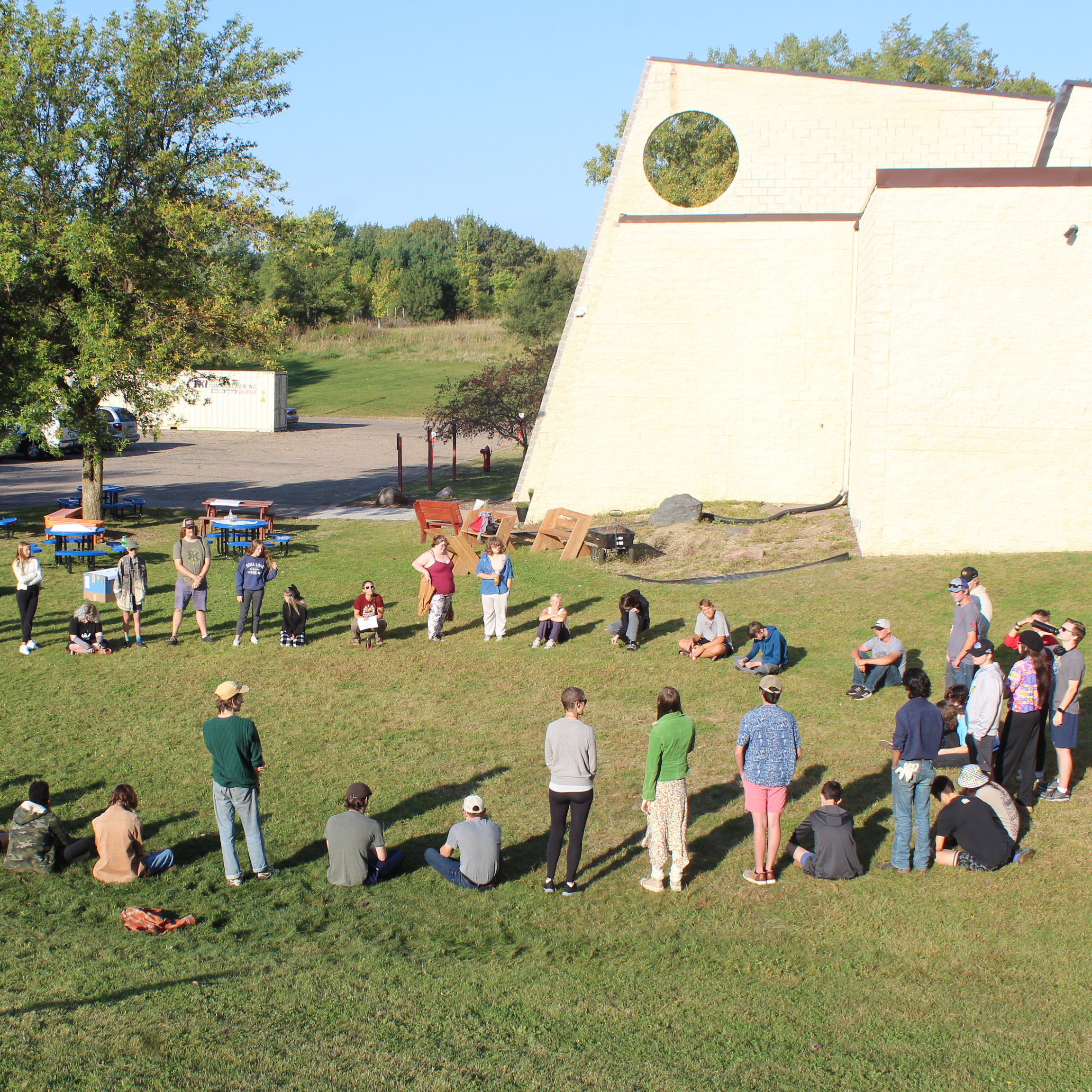 students in circle outside