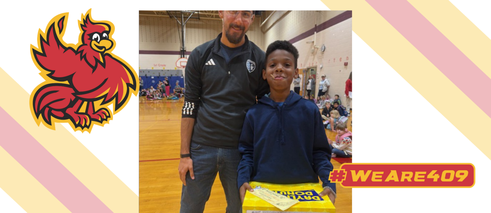 November 9 Phoenix Feather winner Ananais Goodall is pictured with his teacher Mr. Gerlach. Ananais is holding his prize, a box of Daylight Donuts. 