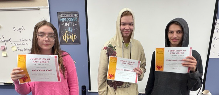Students who have completed credits pose with their certificates