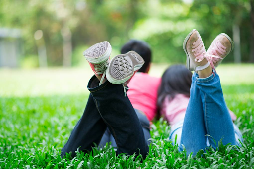 kids laying down in the grass