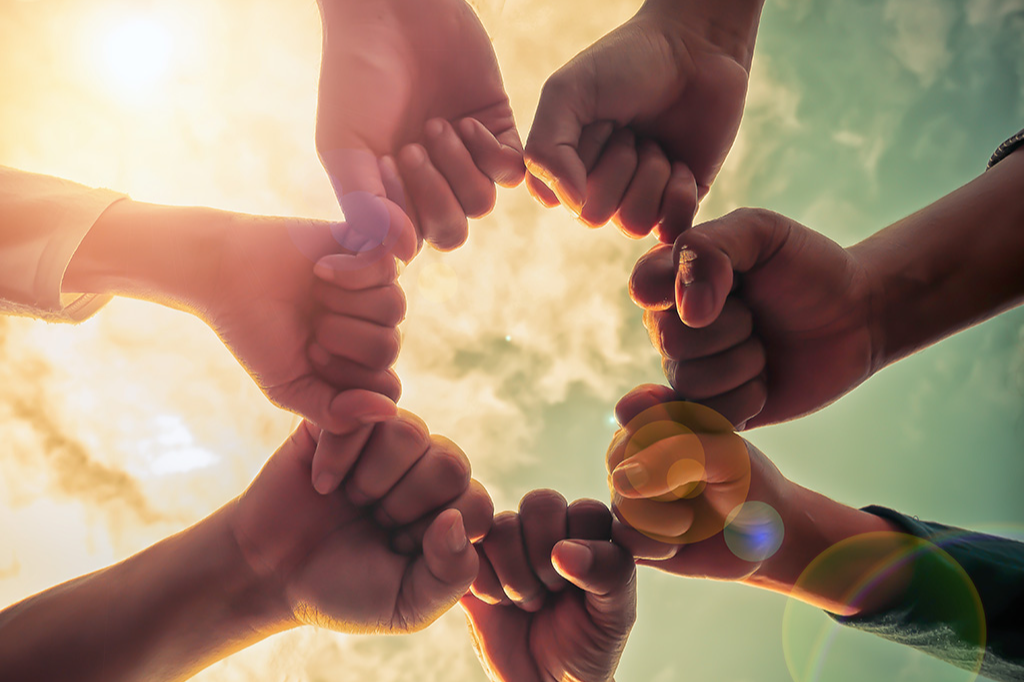 Diverse groups of hands together in a circle