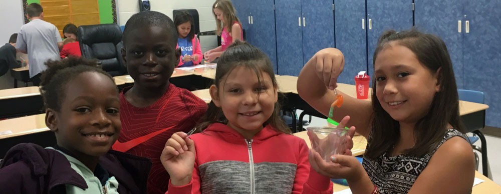 group of students holding gummy bear