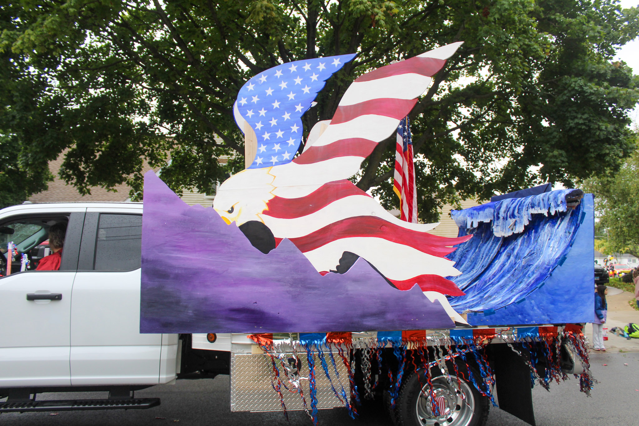 Plainfield Academy float with giant eagle on flatbed