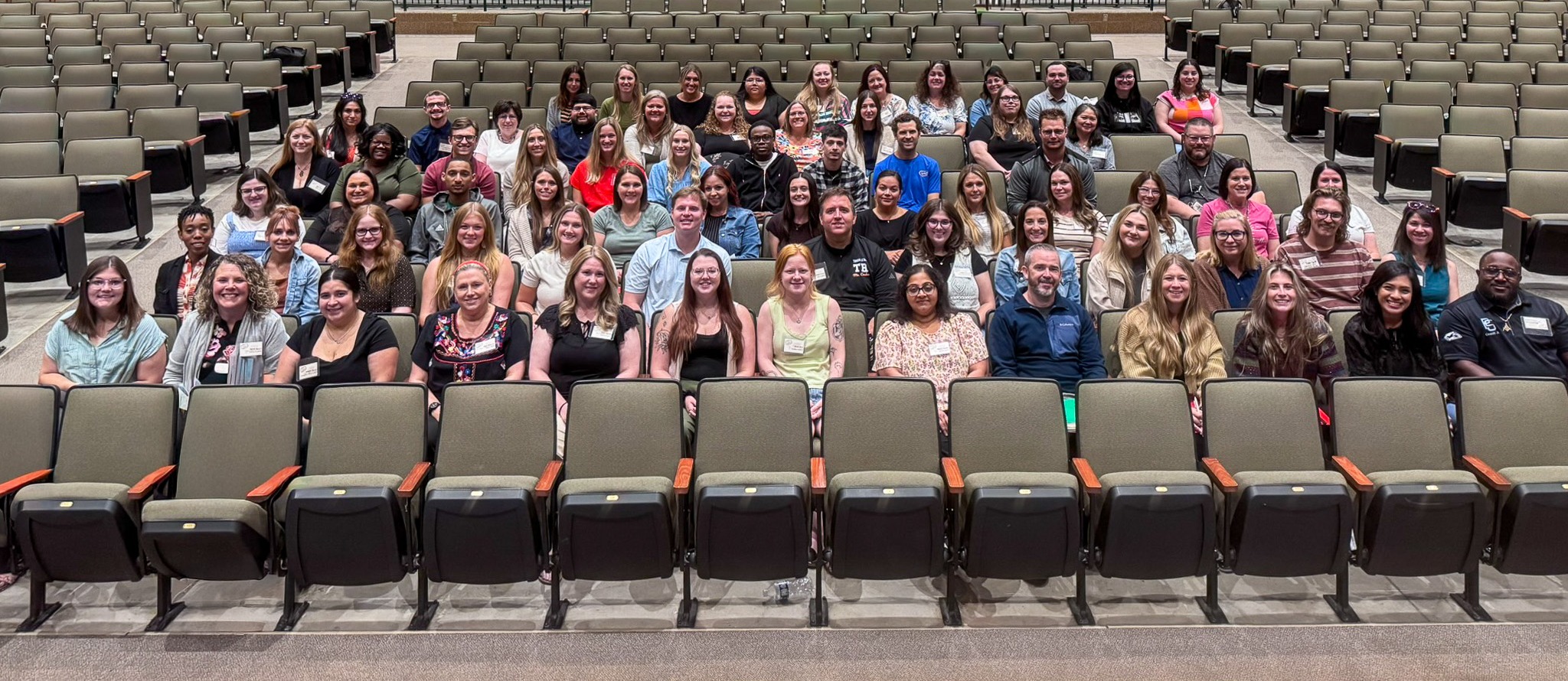 group of adults sitting in auditorium