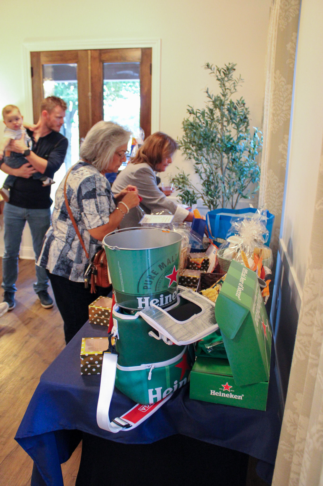 people putting tickets in raffle prize buckets