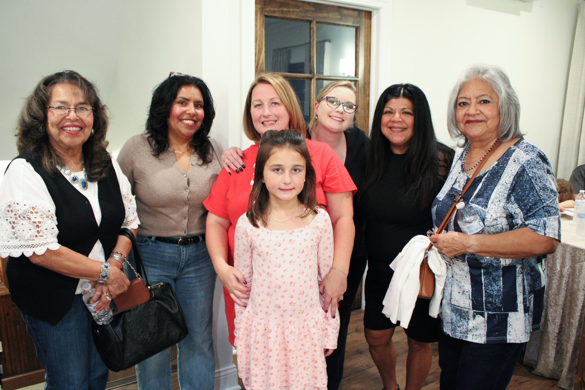 group of woman and girl stand together